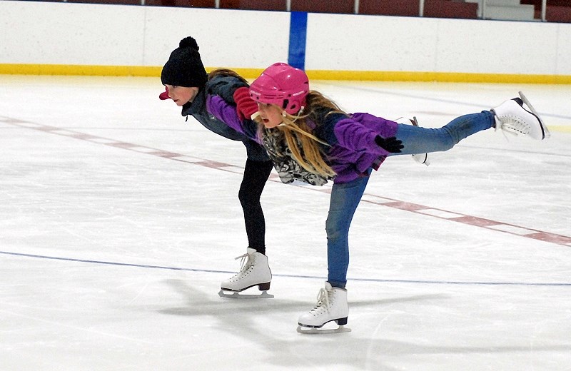 Jaycee Clark, left, and Aspen Luzi demonstrate a synchronized move during a regular Sundre Skating Club practice at the arena last week.