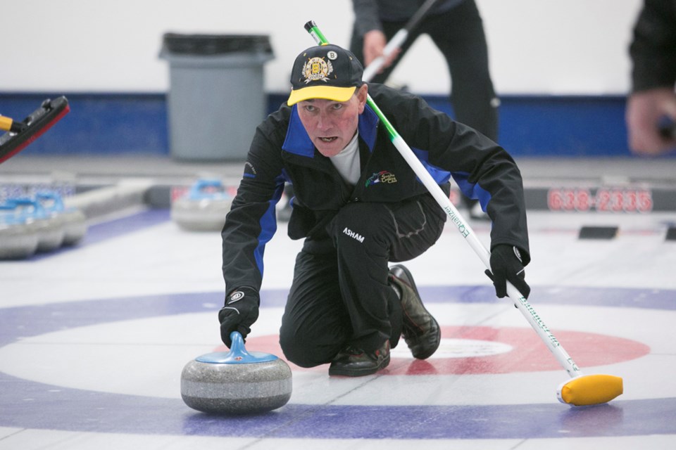 Jeff Rock throws a rock during the men&#8217;s skins bonspiel at the Sundre Curling Club on Friday, Dec. 1. There were 12 teams competing, which was the same as last year.