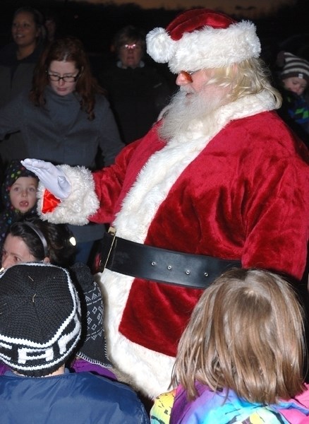 Santa Claus greets the many children who came to see his arrival behind the ball diamonds at River Valley School on Friday, Dec. 4 during one of many Sundown in Sundre events.