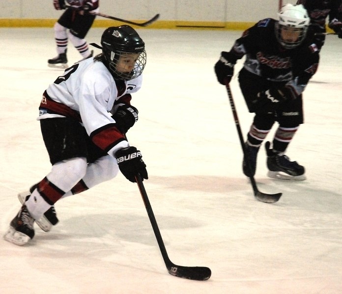 Adam Werezak, captain for the Sundre atom A Huskies, skates the puck up the ice against the Cochrane Rockies on Saturday, Dec. 5 during a three-day tournament hosted by the