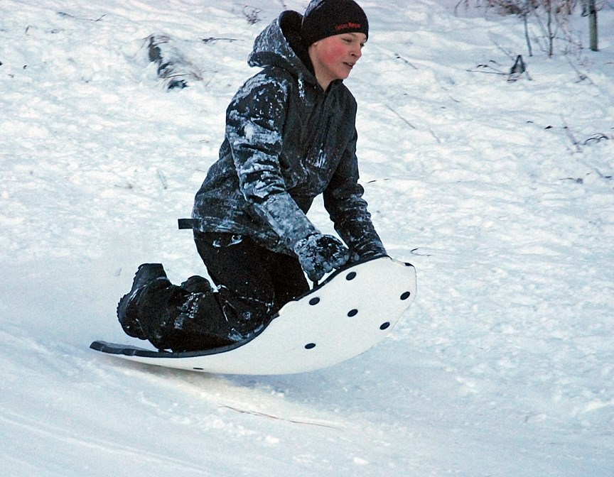 Sundre resident Thiess Larose, 12, grips tightly onto his sled as he launches off of a small jump on Snake Hill last Tuesday, Jan. 2, when the weather finally warmed up