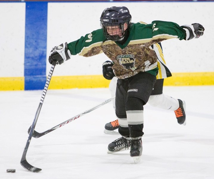 A Cremona player skates down the ice at the local arena with an Olds player on his heels during the Sundre FunTeam Rec Hockey&#8217;s annual tournament this weekend.