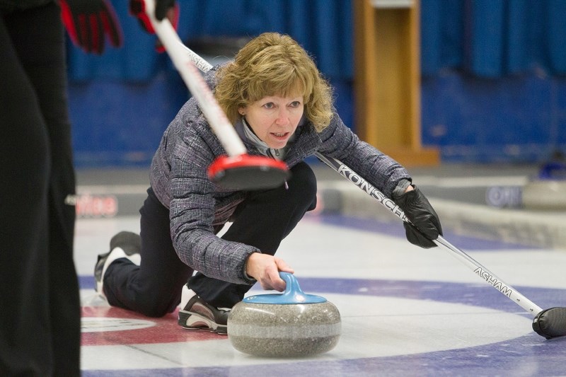 Bev Konschuh keeps steady as she prepares to release a rock during the Sundre Curling Club&#8217;s annual women&#8217;s bonspiel.