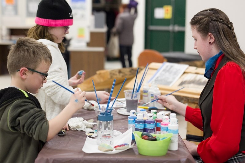 From left, Dillan Burchell, Olivia Burchell and Ryan Voisey enjoyed an opportunity to explore their creative sides by painting rocks during the 2018 Sundre Winterfest, hosted 