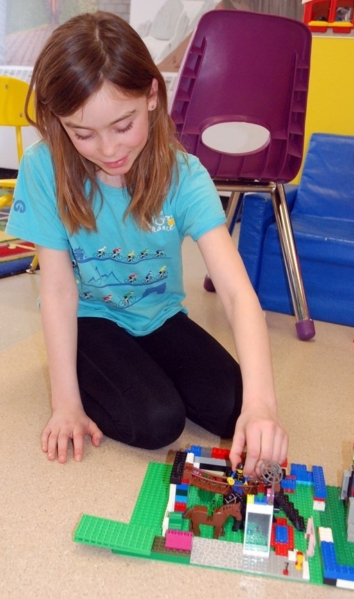 Taylen Lovell, 8, played last week with a horse pasture she made during the Sundre Library&#8217;s weekly Lego Club. Every Tuesday afternoon following regular classes until