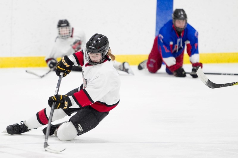 Sundre Husky Lauren French falls on Saturday while chasing down the puck on home ice during the team&#8217;s first game in the best-of-three playoff final against the