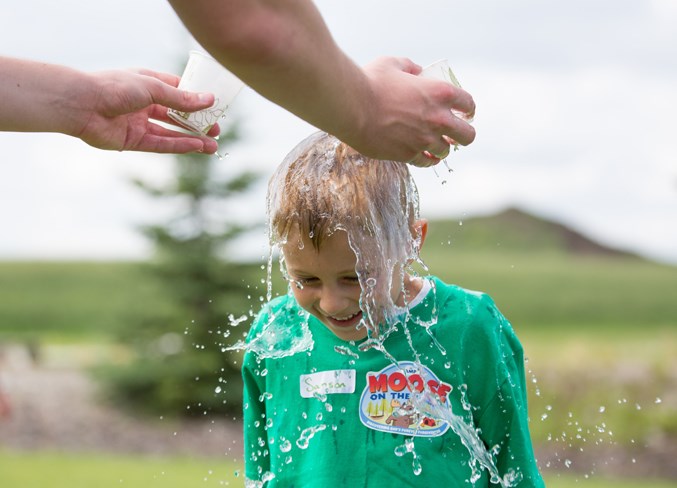 Samson Giesbrecht gets doused with water at the end of the game.