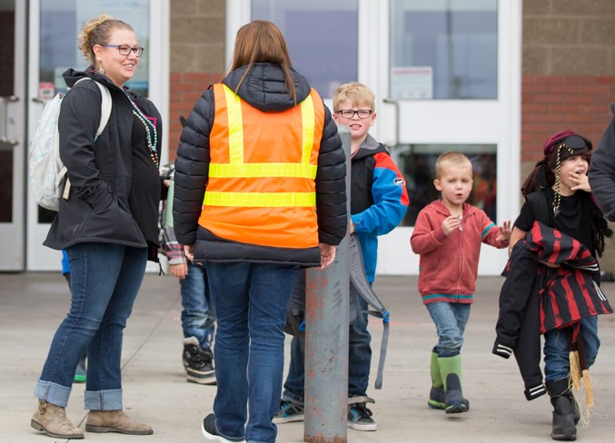 Families leave River Valley School on Sept. 18.