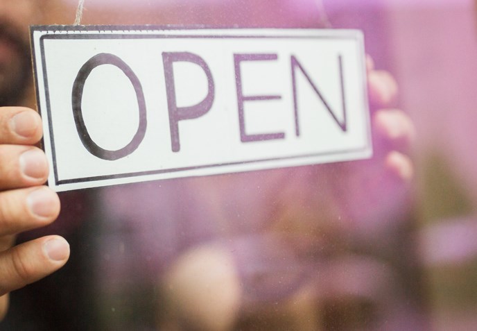 man with open banner at bar or restaurant window