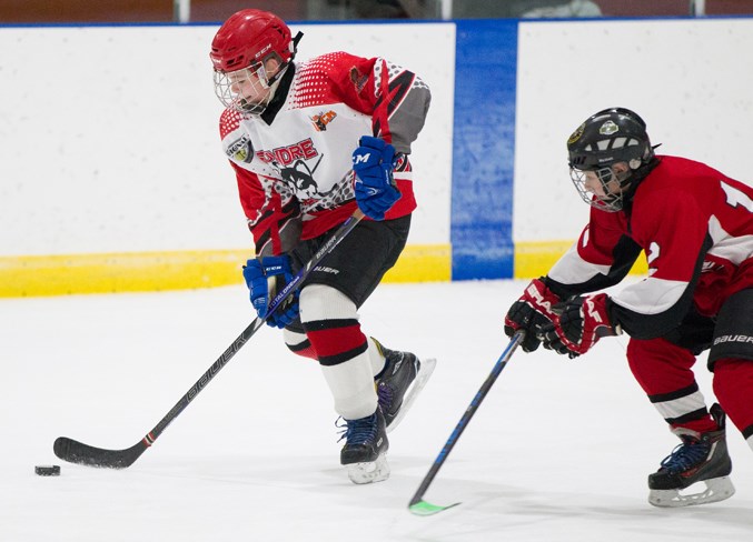 Sundre Huskies PeeWee player Wyatt Bowlen skates down the ice during the game.