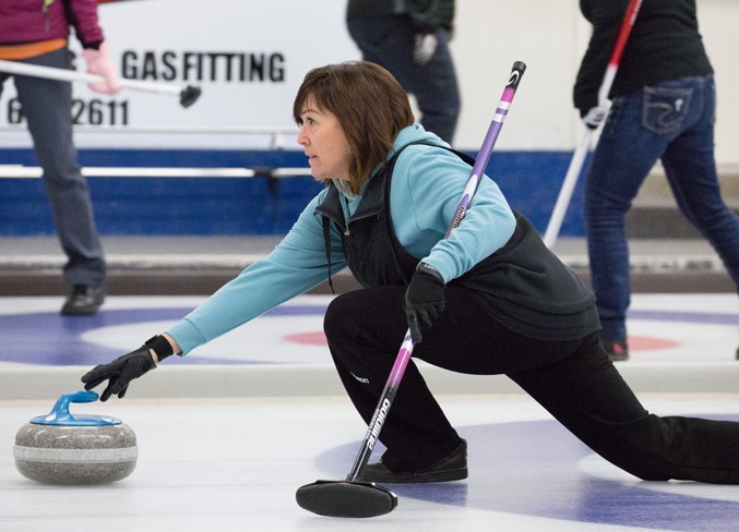 Karen McIntyre throws a rock during the bonspiel.