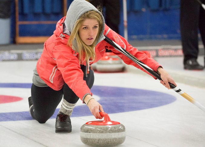 Cali Johnson throws a rock during the bonspiel.