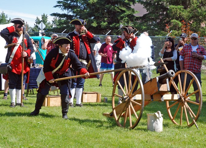  Sarah Jones, the sergeant in charge of the Cannoneers historical re-enactors from Calgary, fires the cannon.