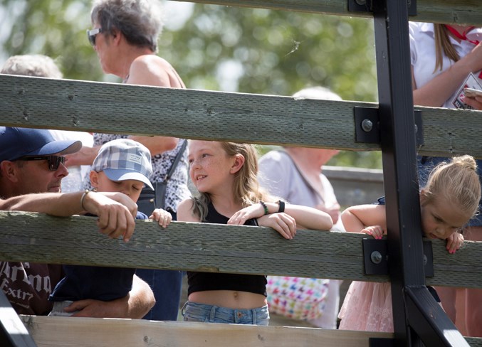  Positioned on the pedestrian bridge, many families watched the rubber ducks floating down the Bearberry Creek on