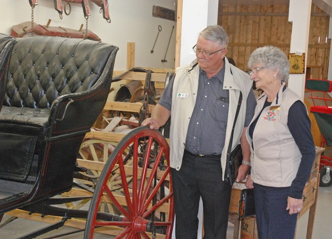  Communities in Bloom judges Bob Côté and Lorna McIlroy take a look at one of the historic horse carriages on display at the museum's pioneer village.