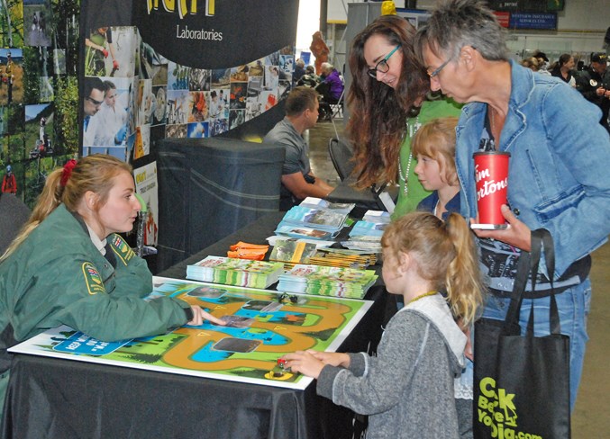  The Freeman family checks out the Alberta Environment and Parks booth. Brooklin Bellavance, a recreation engagement officer with the provincial department who is based in Rocky Mountain House, provided some education about public land use zones.