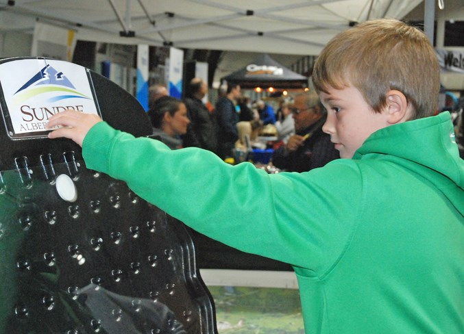  Kade Perry, 6, tries his luck at Plinko at the Town of Sundre’s booth. He came out with his brother CJ, 5, accompanied by mom Nadine Perry and grandmother Freida Kraft, who all live in Sundre.