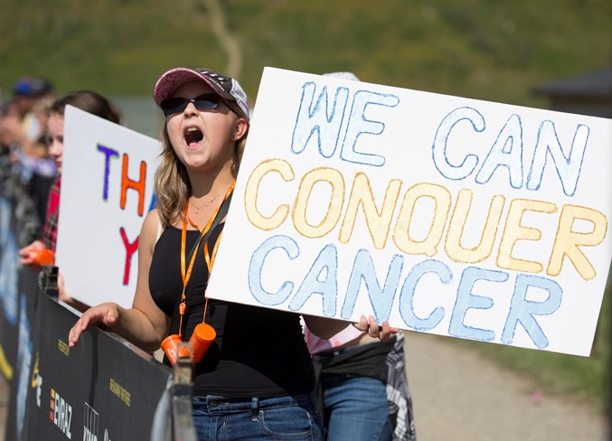  Supporters hold signs at the finish line and cheer on the riders as they arrived on Saturday at the Sundre Rodeo Grounds, where a tent city was set up for the weekend.