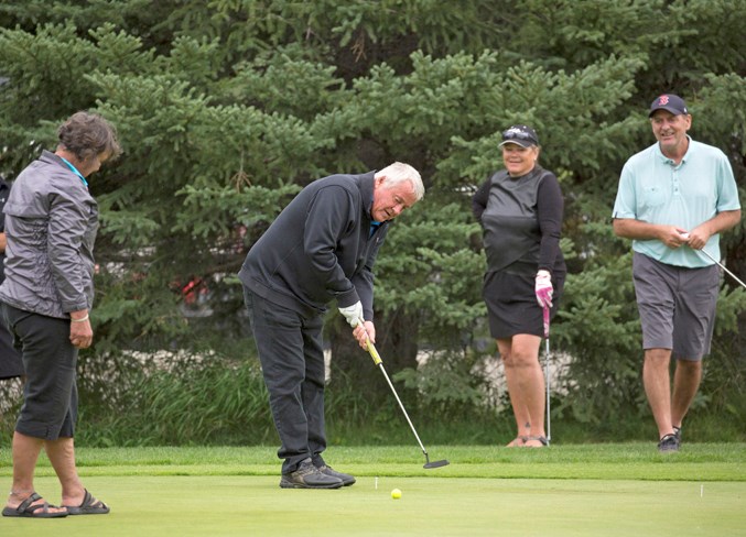 Dale McNaught takes part in a putting contest during the tournament.