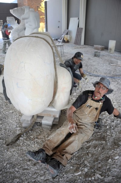 Bergen Rocks International Sculpture Symposium founder Morton Burke (front) assists China&#8217;s Li Chao.