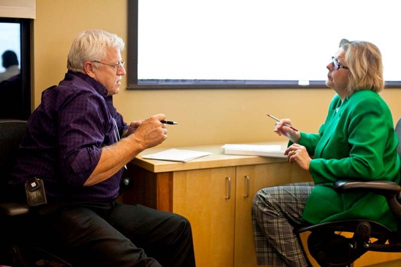 Mountain View County councillor Al Kemmere and Olds Mayor Judy Dahl talk during the all-council MAP meeting last Wednesday.