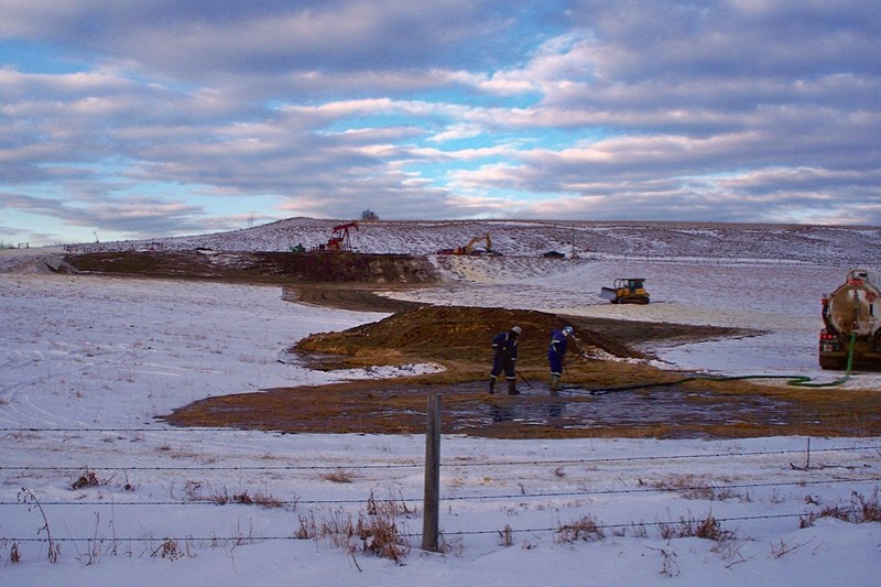 Workers clean up at the site of the oil well blowout that occured near Gleniffer Lake on Jan. 13.