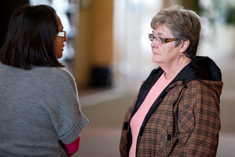 Glenda Hunsperger speaks with Mountain View County planner Dolu Gonzalez after Wednesday&#8217;s public hearing.