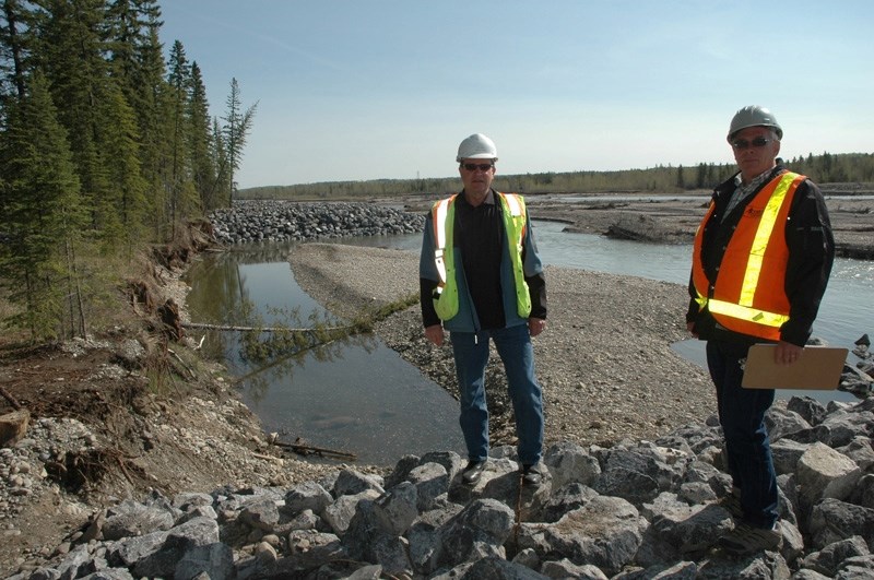 Dave Halwa of Stantec Consulting (right) and Ron Baker of the Town of Sundre stand on one of six new riverbank flood protection spurs.