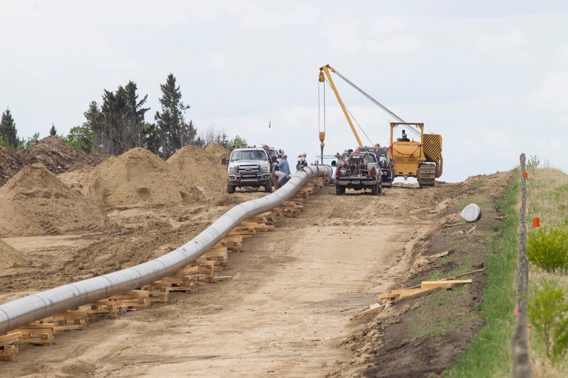 Workers attach two sections of pipeline between Innisfail and Bowden last Thursday. Construction on the twinned water and wastewater lines from Bowden to Olds is expected to