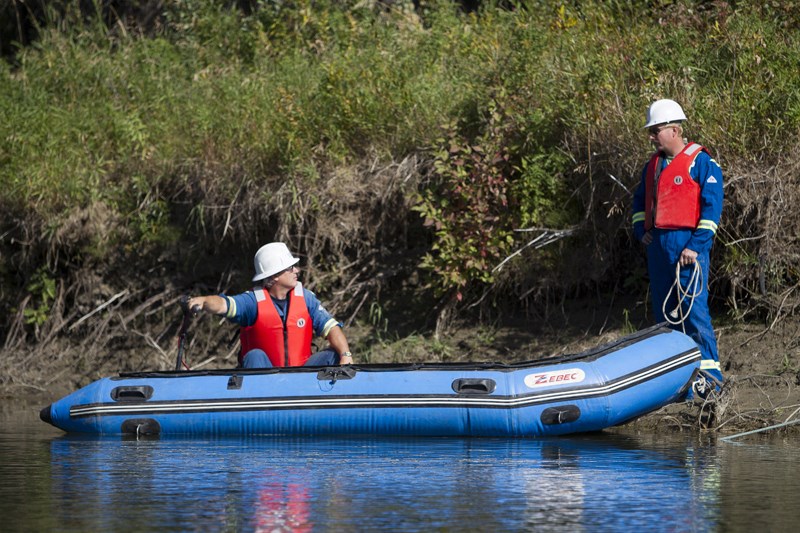 Participants in a spill training exercise deploy a containment boom