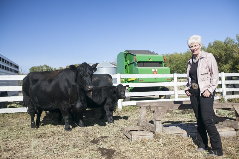 Mabel Hamilton stands with Angus cattle on her property