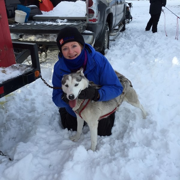 Dena Wannamaker gives the dog Shelby a hug following a practice run on Dec. 27.