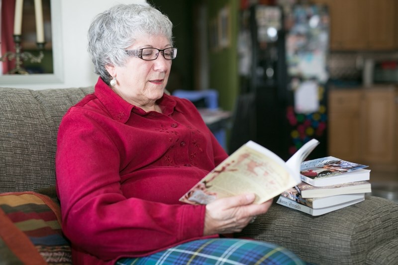 Victoria Chatham looks over one of her books at her home in Carstairs on Jan. 7.