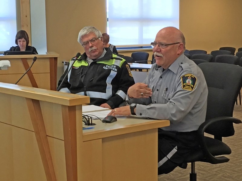 Mountain View County peace officers Kevin Heppler, right, and Rob Ridley speak with county councillors on Feb. 8.