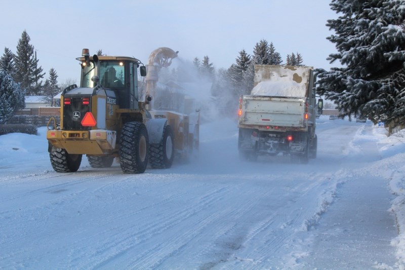 Crews clear snow on a Didsbury street on Feb. 7. Snow across the region kept crews busy for several days.