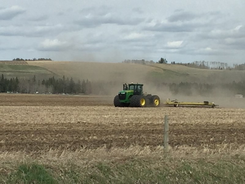 Crews work in a field west of Sundre off Highway 584. Planting work is underway across the region.