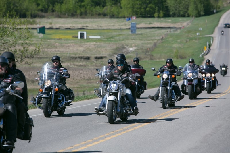 Bikers make their way along a Mountain View County highway during the recent Bikers Against Child Abuse ride.