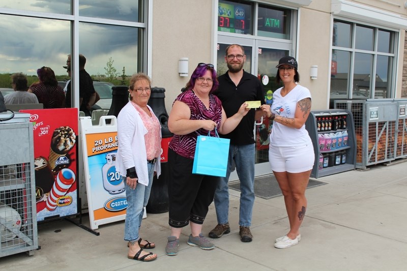 Essentials for our Community had the draw for its recent raffle of a cast iron garden bench as well as a couple of gift packages. Helping with the draw were, from left, board 