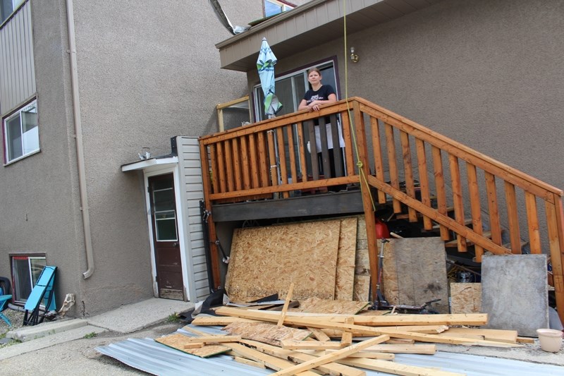 Angela Blacquiere, who co-owns and operates the Didsbury Inn-Country Nook with her husband, looks over some of the damage caused by the big windstorm last week.