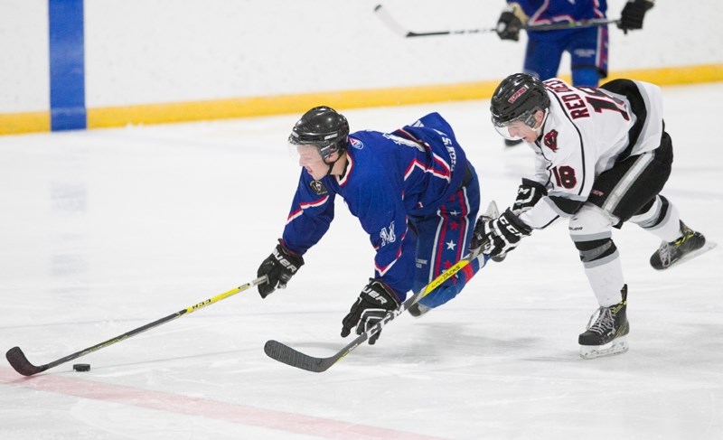 Mountainview Colts player Tyson Schmidt gets tripped up by a Red Deer Vipers player during a playoff game in March.