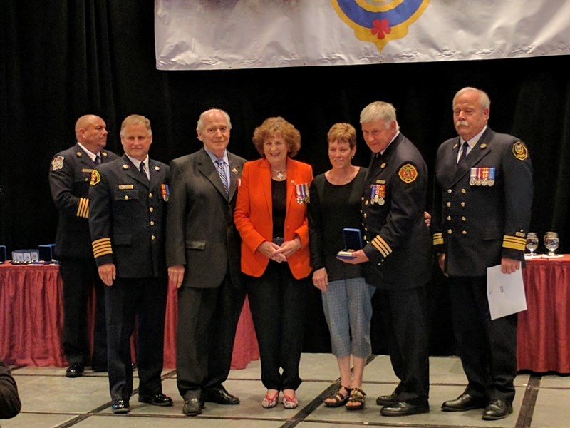 Bob Wright, second from right, along with wife Fran, third from right, receives a merit award for 40 years of service with the Didsbury Fire Department from Lt.-Gov. Lois