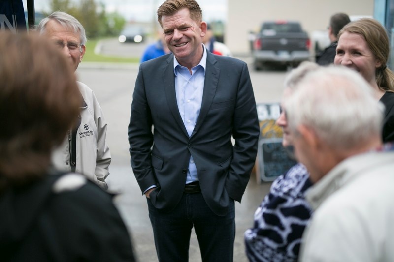 Wildrose leader Brian Jean speaks with constituents during a rally at Reimer Plaza in Didsbury on June 14.