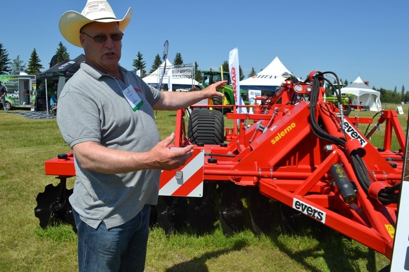 Mountain View County resident Jan Broekman, with ABC Agri, explains the workings of an Evers vario-disc high-speed harrow during last week&#8217;s FutureFarm Canada Expo at