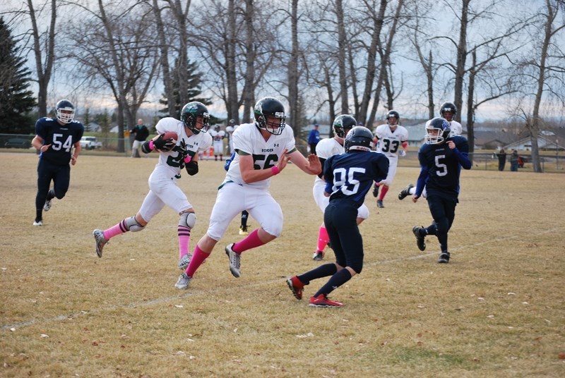 Didsbury Dragon&#8217;s running back Tyler Rude runs the ball in for a touchdown with the help of a timely block from centre Austin Cornelson during the championship game on