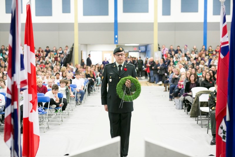 Cpl. Owen Tuckey with 41 Combat Engineer Regiment, prepares to lay a wreath of remembrance during the Nov. 7 service at Hugh Sutherland school in Carstairs.