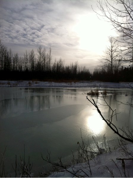 Sun sets on the Bearberry Creek and the Red Deer River outside Sundre.