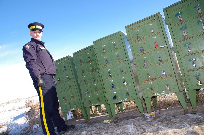 Didsbury RCMP Const. Sheldon Krasniuk in front of rural mail boxes in Mountain View County. Vandalism of the mail boxes has been an ongoing concern for both RCMP and the Olds 