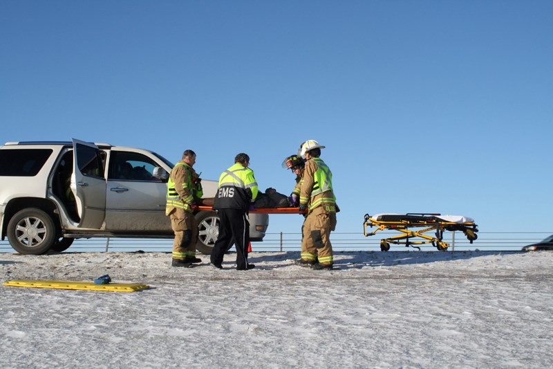 Crews help a crash victim on Highway 2.