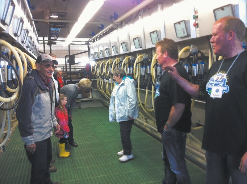 Guests tour the dairy east of Olds.