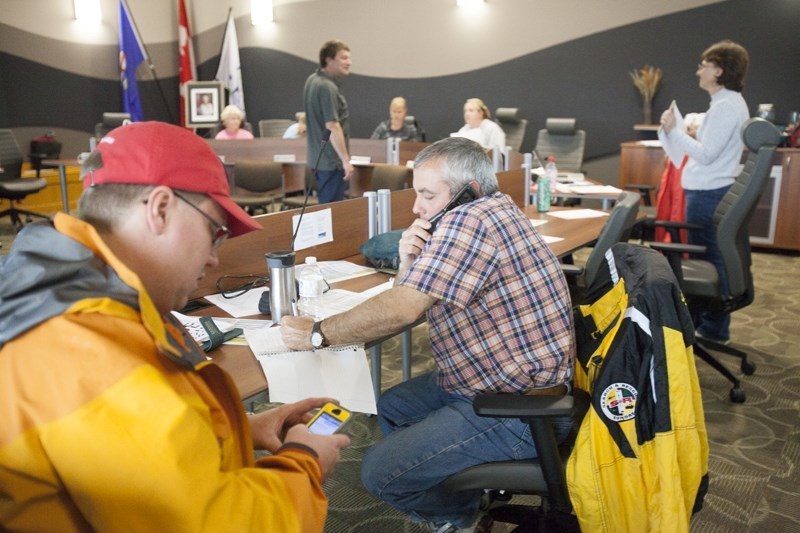 Officials work in the Sundre EOC in June.